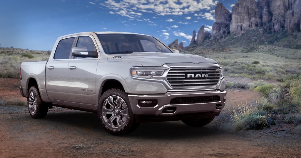 A silver 2021 Ram 1500 Limited Longhorn 10th Anniversary Edition pickup truck parked in a desert is now one of the most discounted new cars