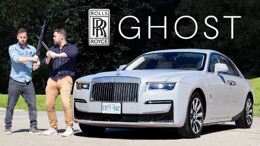 The Throttle House hosts jousting with umbrellas next to a gray 2021 Rolls-Royce Ghost