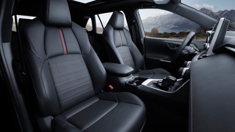 The interior of a 2021 Toyota RAV4 Prime hybrid compact crossover SUV with a panoramic sunroof and black-leather seating