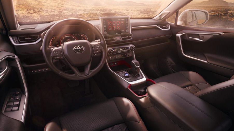 The black-and-red cockpit of a 2021 Toyota RAV4 TRD Off-Road compact crossover SUV