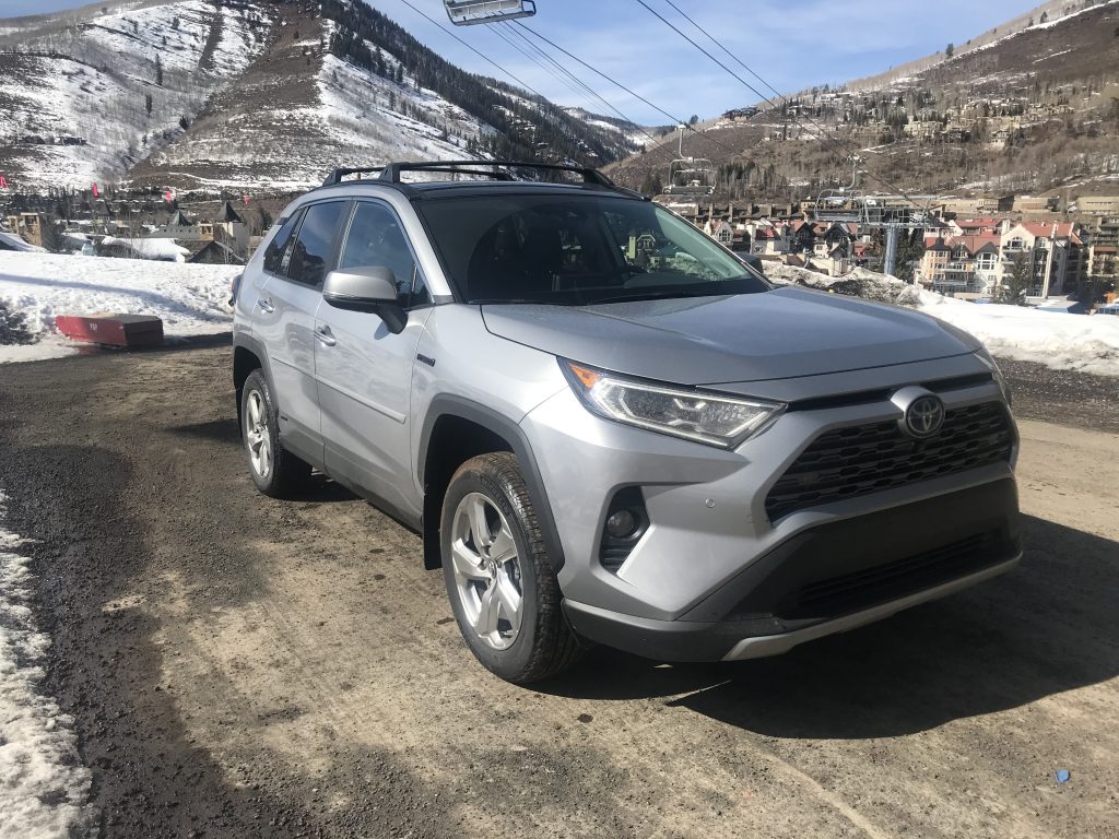 a front shot of the 2021 Toyota RAV4 Hybrid next to a ski slope