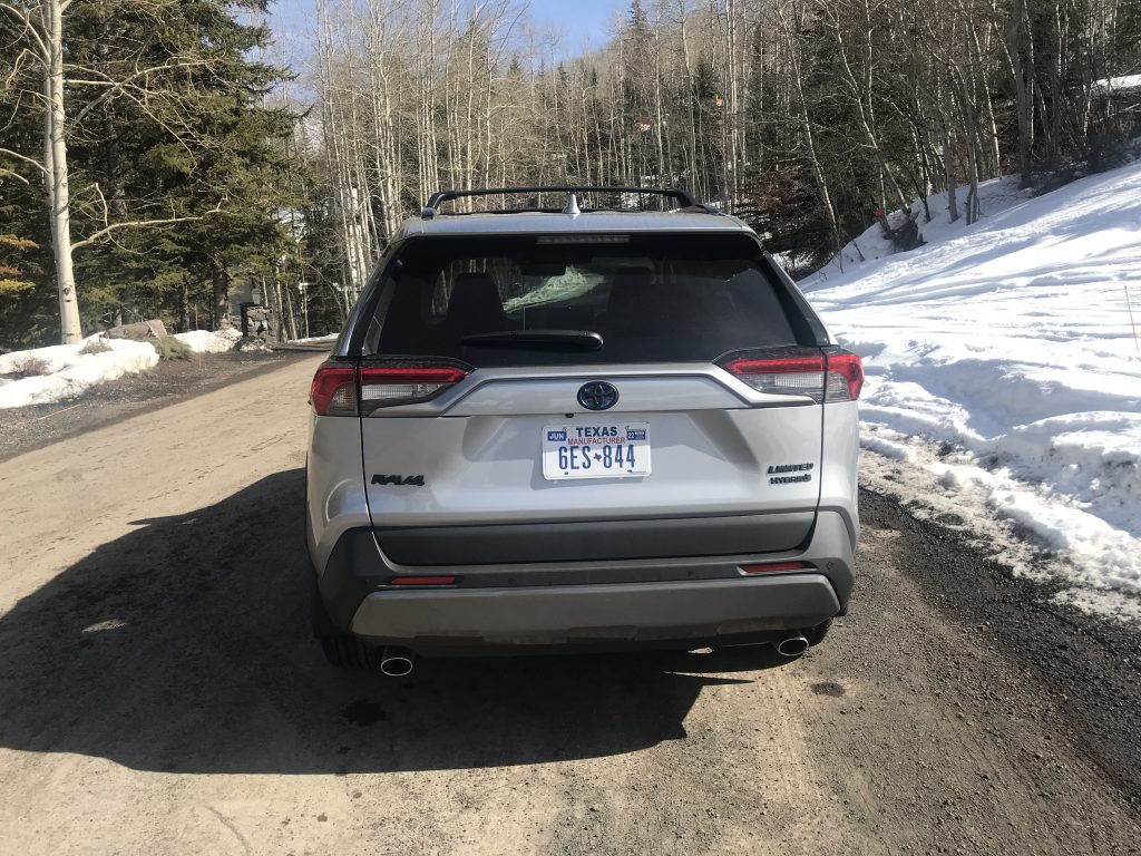 A rear shot of the 2021 Toyota RAV4 Hybrid  on a ski slope
