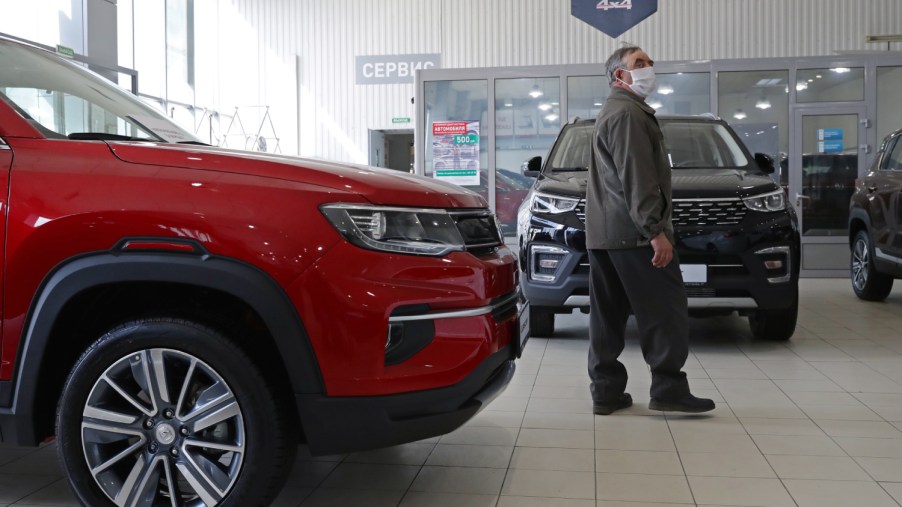 A potential customer browses cars at a car dealership