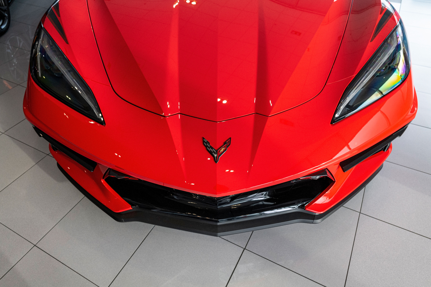 A red 2021 Chevrolet Corvette on display at a dealership