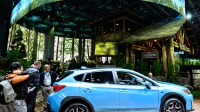 A blue 2021 Subaru Crosstrek Hybrid on a nature display at the New York Auto Show