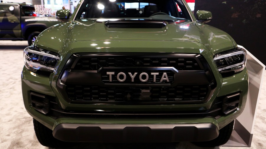 A green Toyota Tacoma with the TRD Pro grille style on display