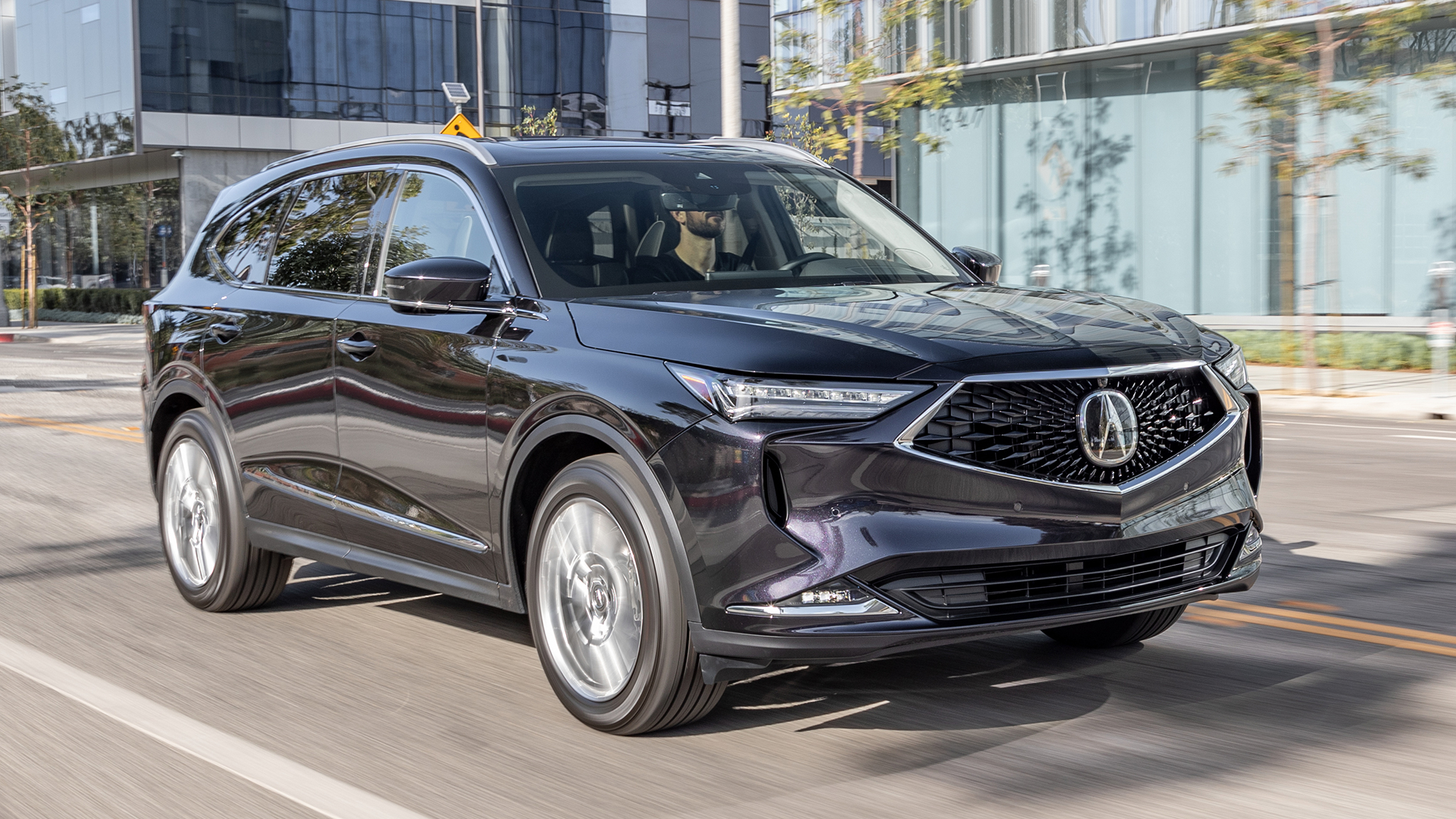 The 2022 Acura MDX driving through a city