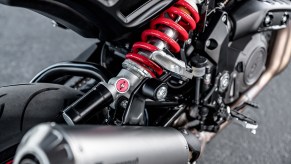 A close-up view of a black 2022 Indian FTR S's red-spring rear monoshock