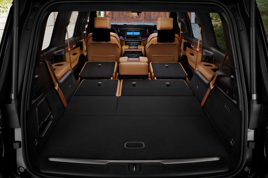The rear view of the tan-leather interior of a 2022 Jeep Grand Wagoneer with its second- and third-row seats folded