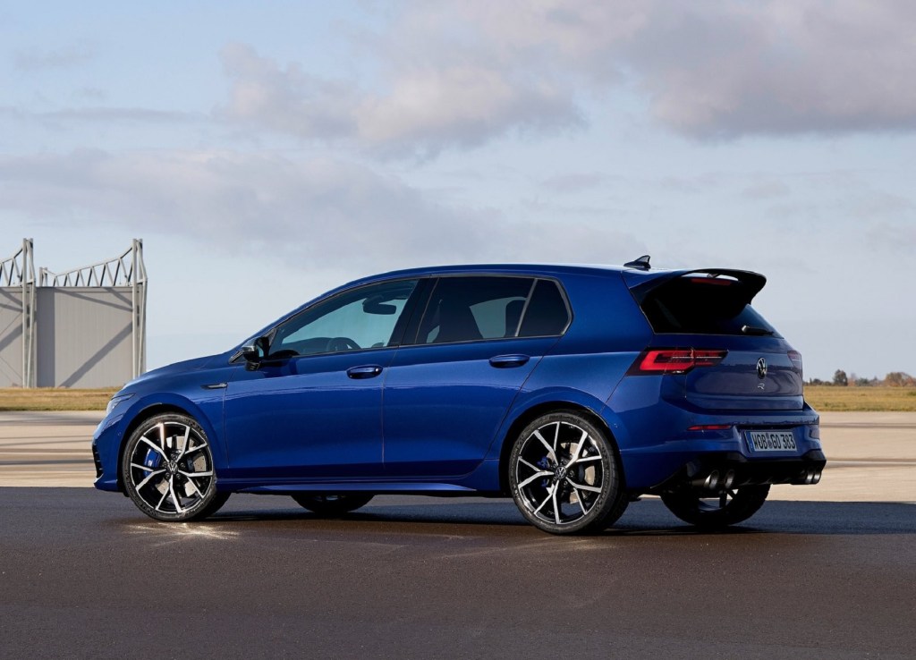 The rear 3/4 view of a blue 2022 Volkswagen Golf R on an airstrip