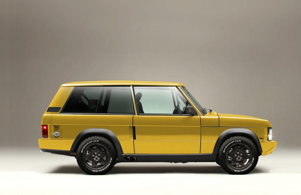 An image of a yellow Range Rover Chieftain by Jensen International Automotive inside of a studio.