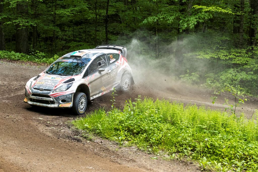 The white #97 Ford Fiesta slides on a dirt forest trail at the 2017 Susquehannock Trail Performance Rally in Pennsylvania