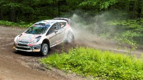 The white #97 Ford Fiesta slides on a dirt forest trail at the 2017 Susquehannock Trail Performance Rally in Pennsylvania