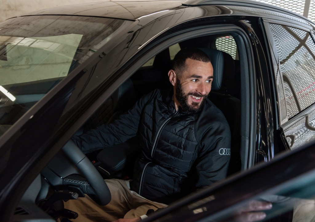 Karim Benzema behind the wheel of a new black Audi sedan