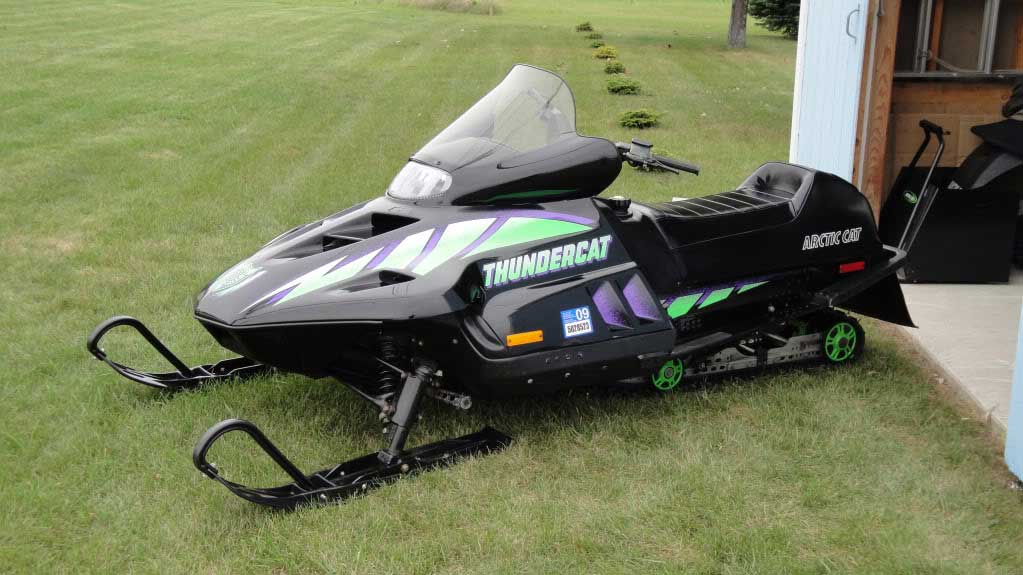 a throwback 1990s Arctic Cat Thundercat in the grass on display in the off-season