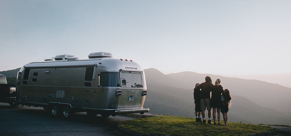 A family enjoying the view with their Airstream Flying Cloud travel trailer 