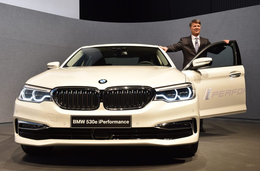 A BMW employee poses next to a 530e