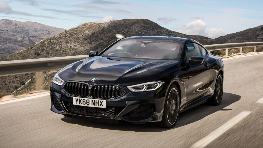 A black BMW 8-Series outdoors on the road.