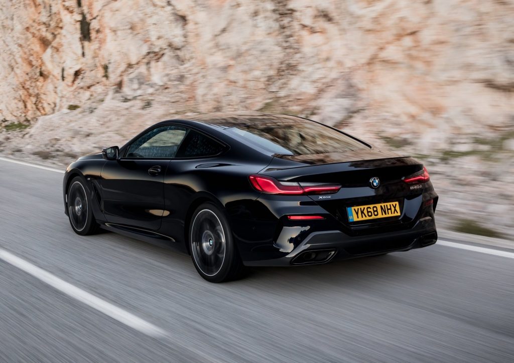 A black BMW 8-Series outdoors on the road.