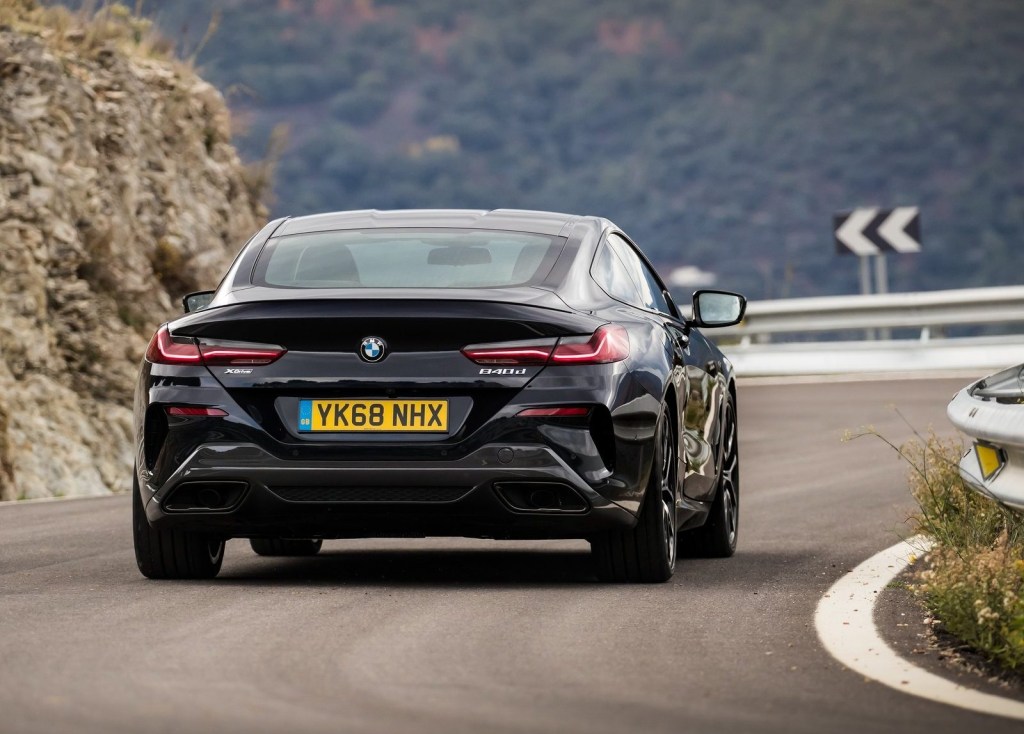 A black BMW 8-Series outdoors on the road.