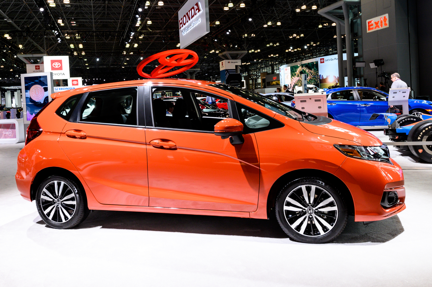 An orange 2016 Honda Fit sits on display