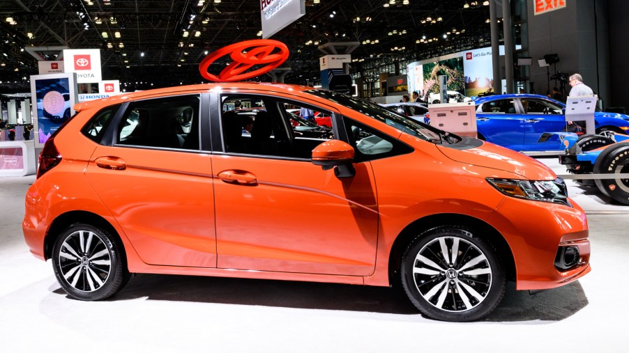 An orange 2016 Honda Fit sits on display