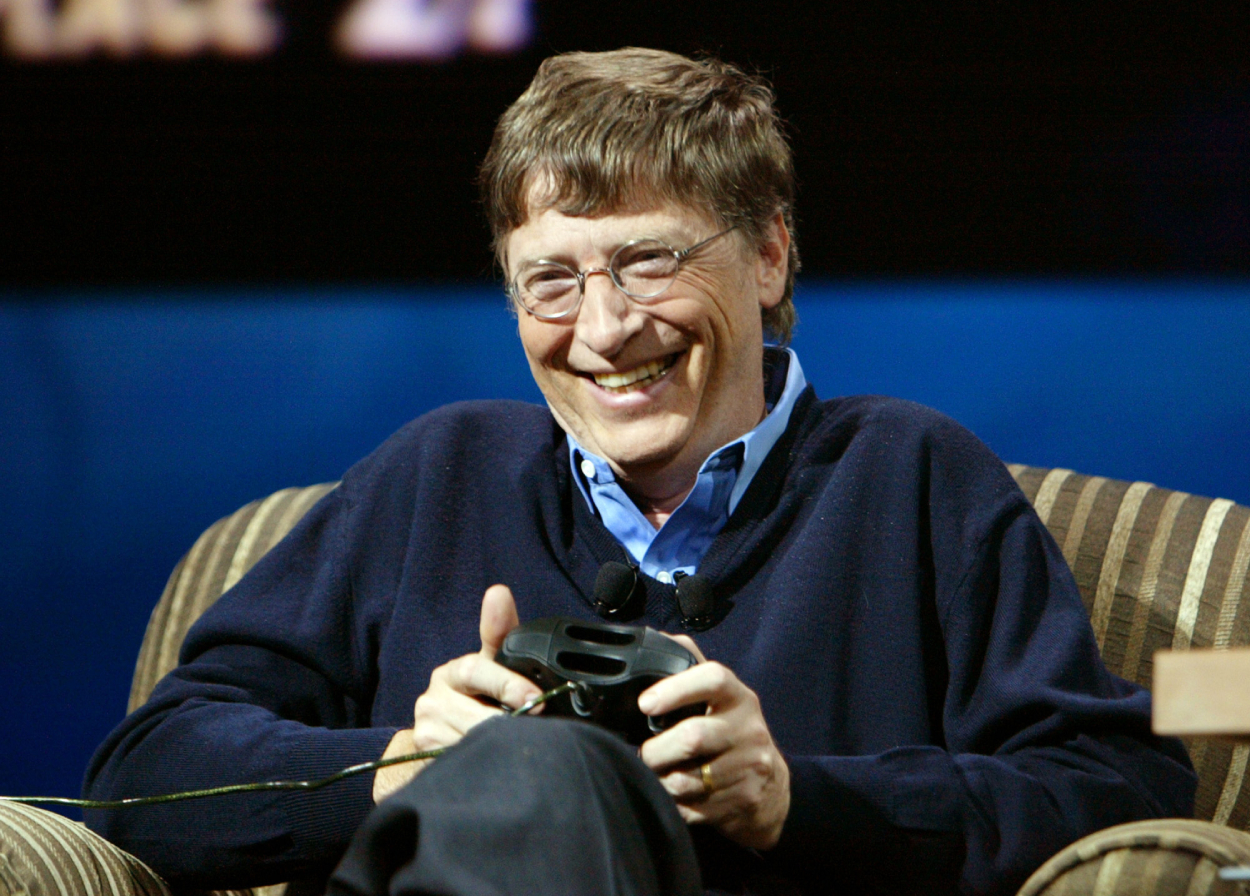 Bill Gates laughs while playing Xbox