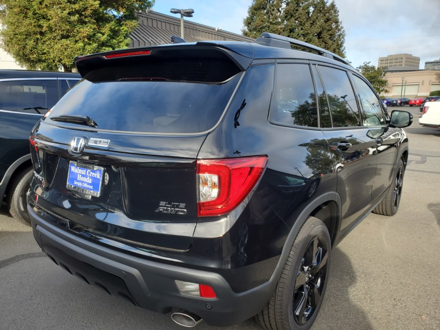 A black Honda Passport seen from the side