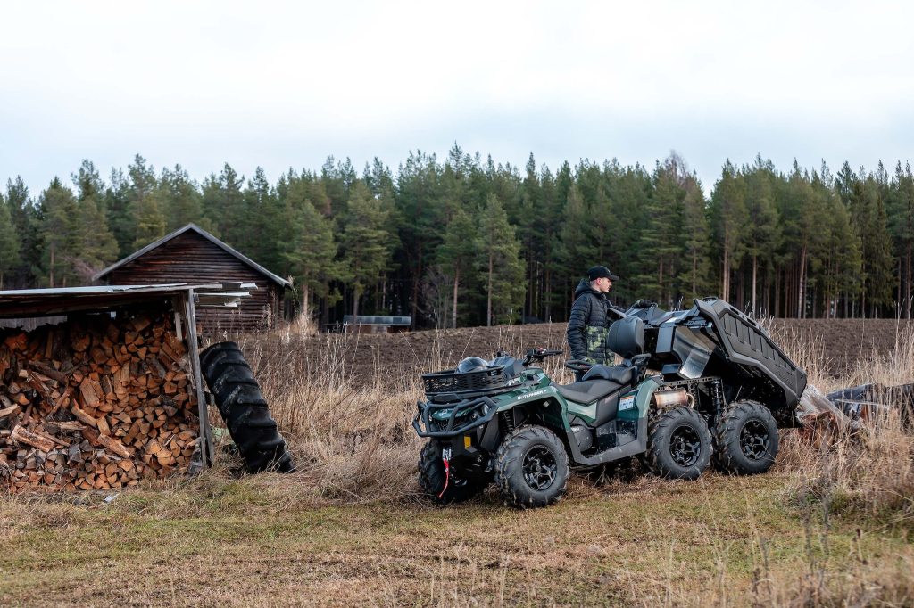 The Can-Am Outlander doing work on a rustic ranch