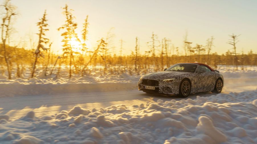 A camouflaged 2022 Mercedes-AMG SL with a red roof undergoing winter testing