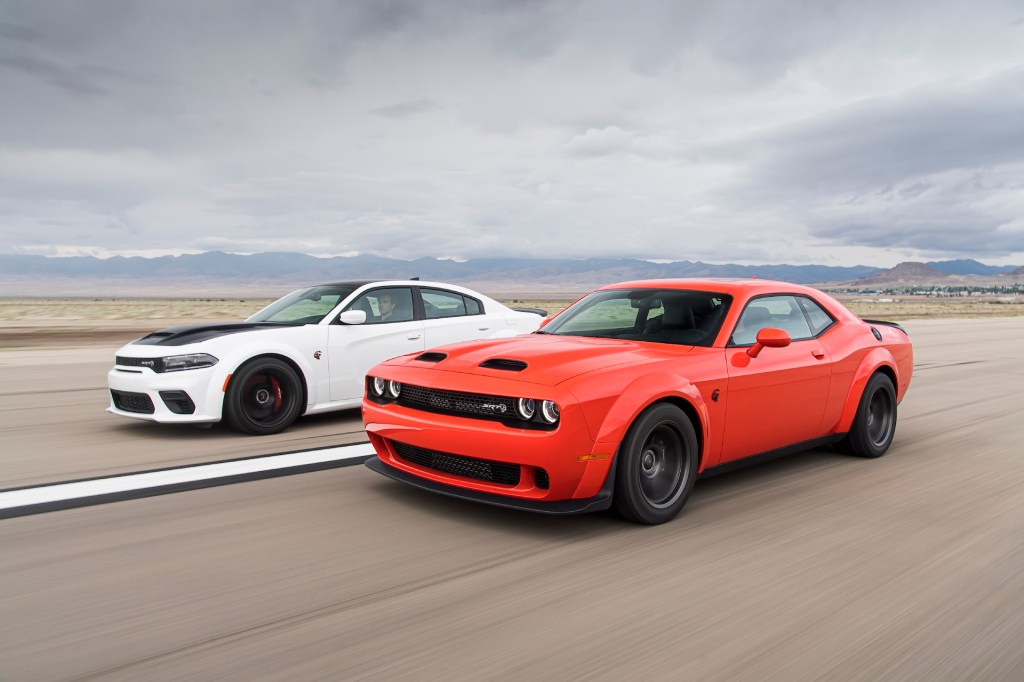 An image of a Dodge Challenger and Charger out on an airfield.