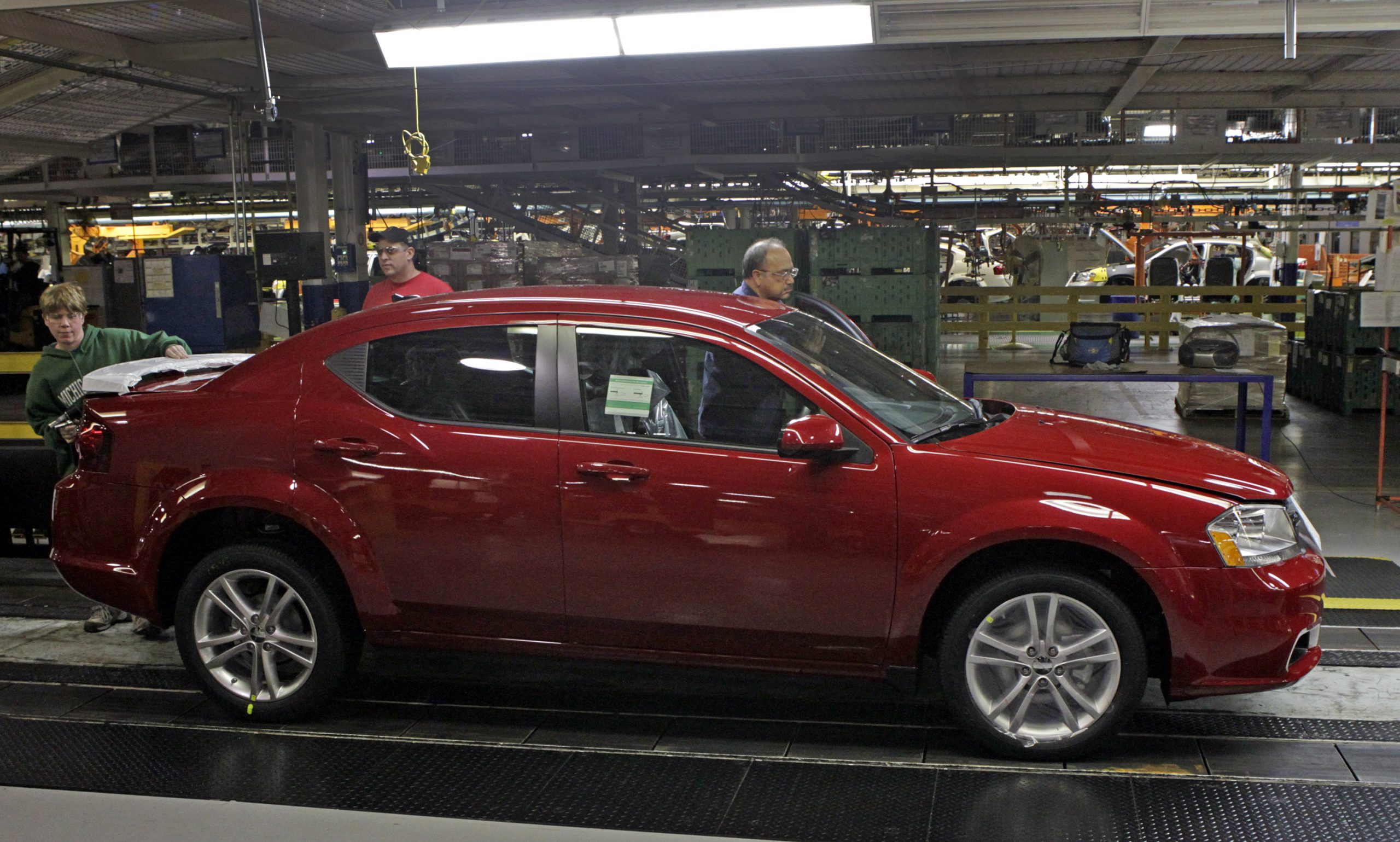 Workers inspect the 2011 Dodge Avenger at Chrysler Group's production plant in Sterling Heights, Michigan