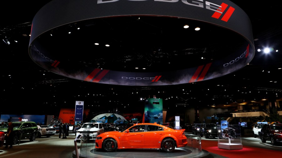 An orange Dodge Charger SXT on display at the Chicago Auto Show
