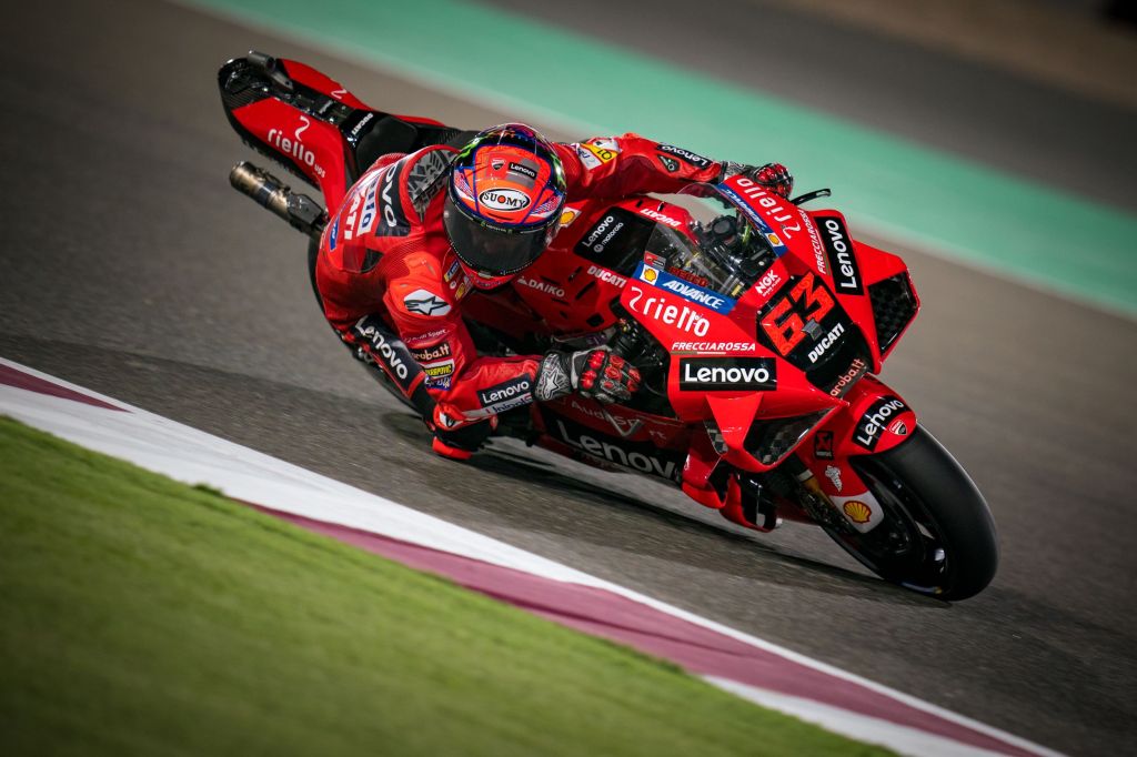 Red-clad Ducati Lenovo MotoGP rider Francesco Bagnaia takes a corner at the 2021 Qatar GP