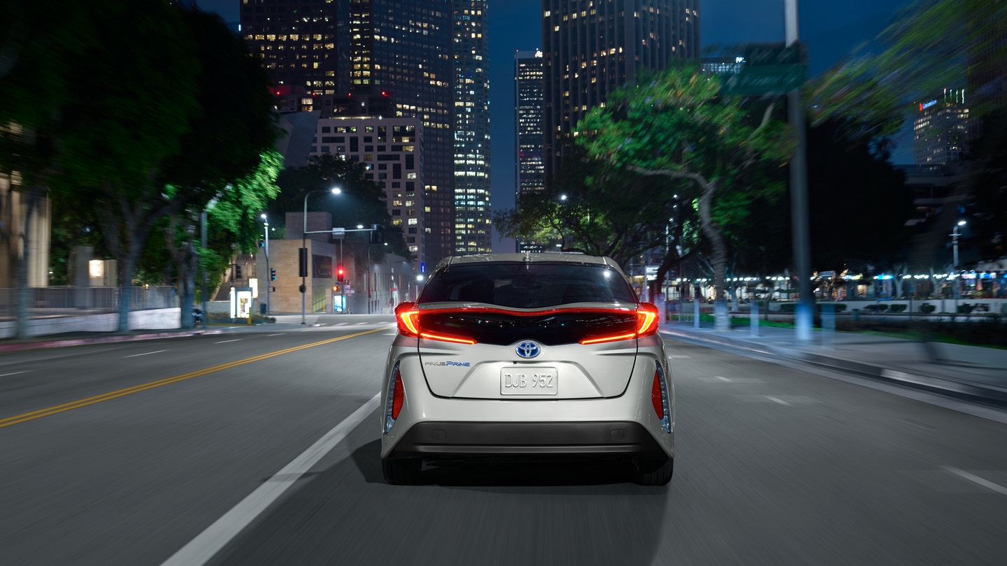 rear view of a 2021 toyota prius prime model at night in the city