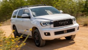 a white 2021 Sequoia driving on a dirt road