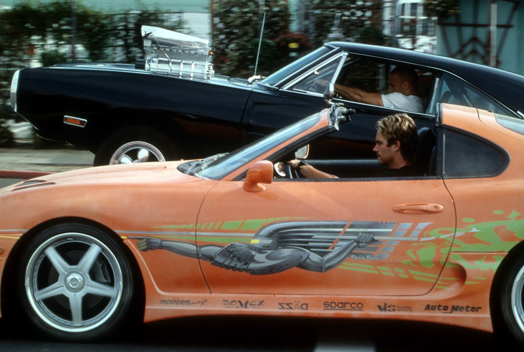 Vin Diesel and Paul Walker racing against each other in a scene from the film 'The Fast And The Furious.'