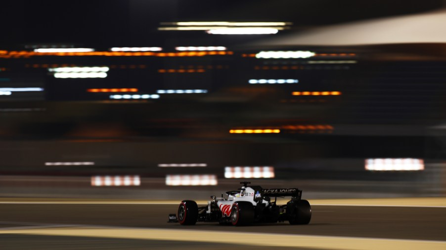 A Formula 1 Haas F1 Team race car moves down the track at a high rate of speed