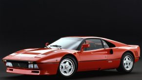 An image of a Ferrari 288 GTO parked inside of a studio.