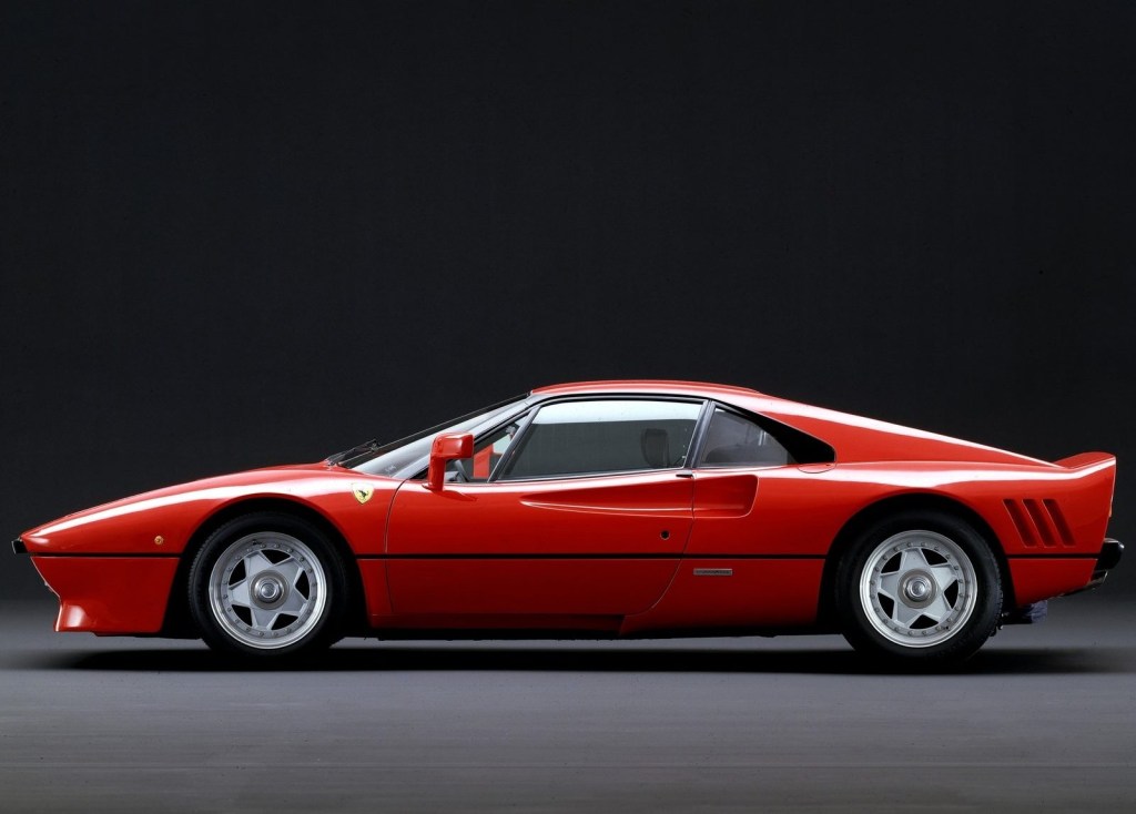 An image of a Ferrari 288 GTO parked inside of a studio.