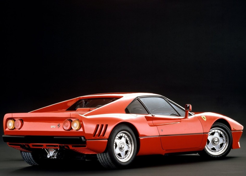 An image of a Ferrari 288 GTO parked inside of a studio.