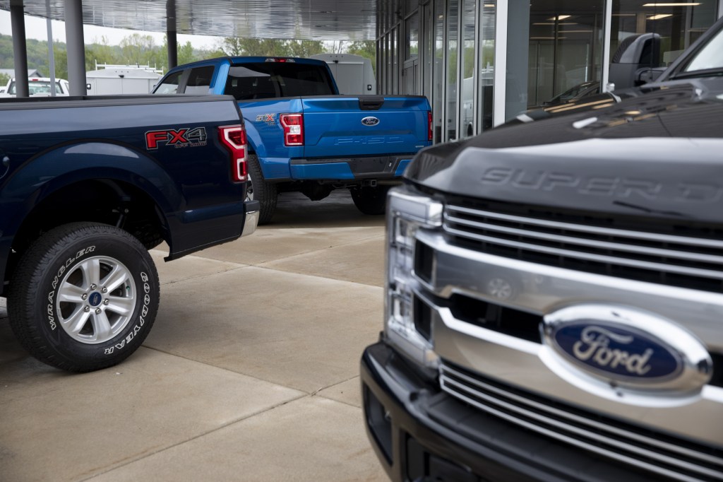 Ford F-150 trucks sit as display cars at a dealership