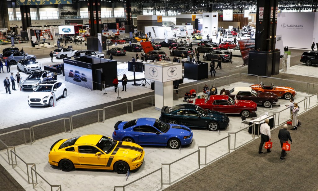 A row of Ford Mustang cars on display at an auto show