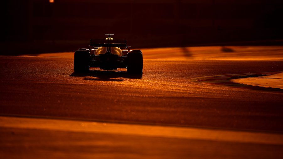 Formula 1 driver going around Bahrain at dusk