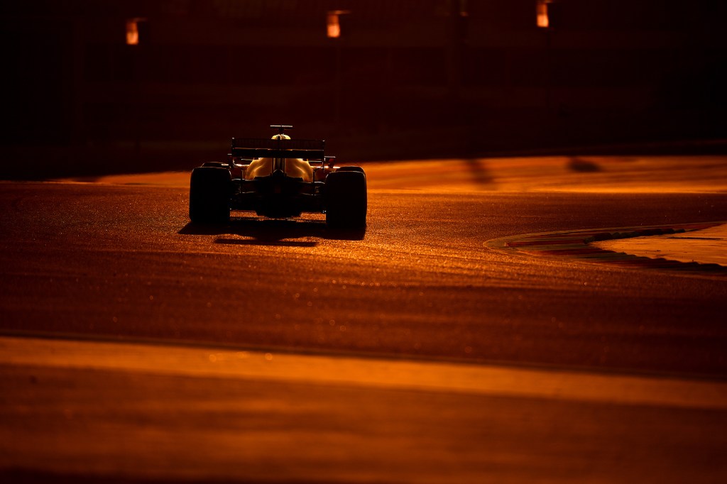 Formula 1 driver going around Bahrain at dusk
