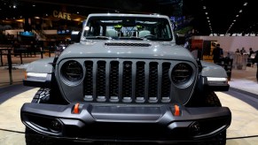 The front grille of a Jeep Gladiator on display at an auto show