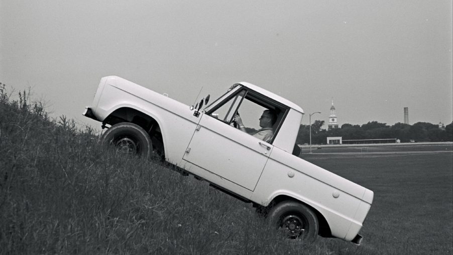 A 1966 Ford Bronco climbing a steep hill