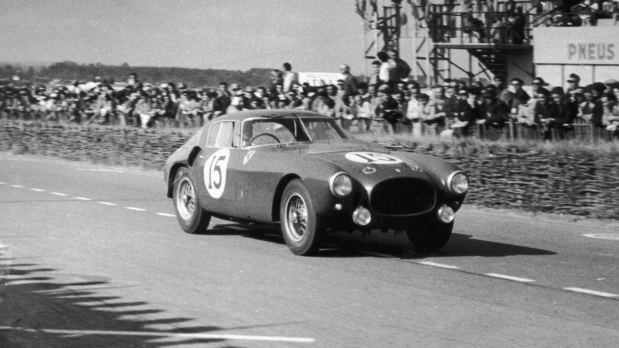 A black and white image of a Ferrari 375 MM out on a track.
