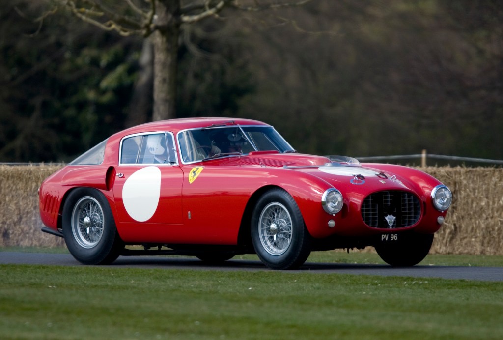 An image of a red Ferrari 375 MM parked outdoors.