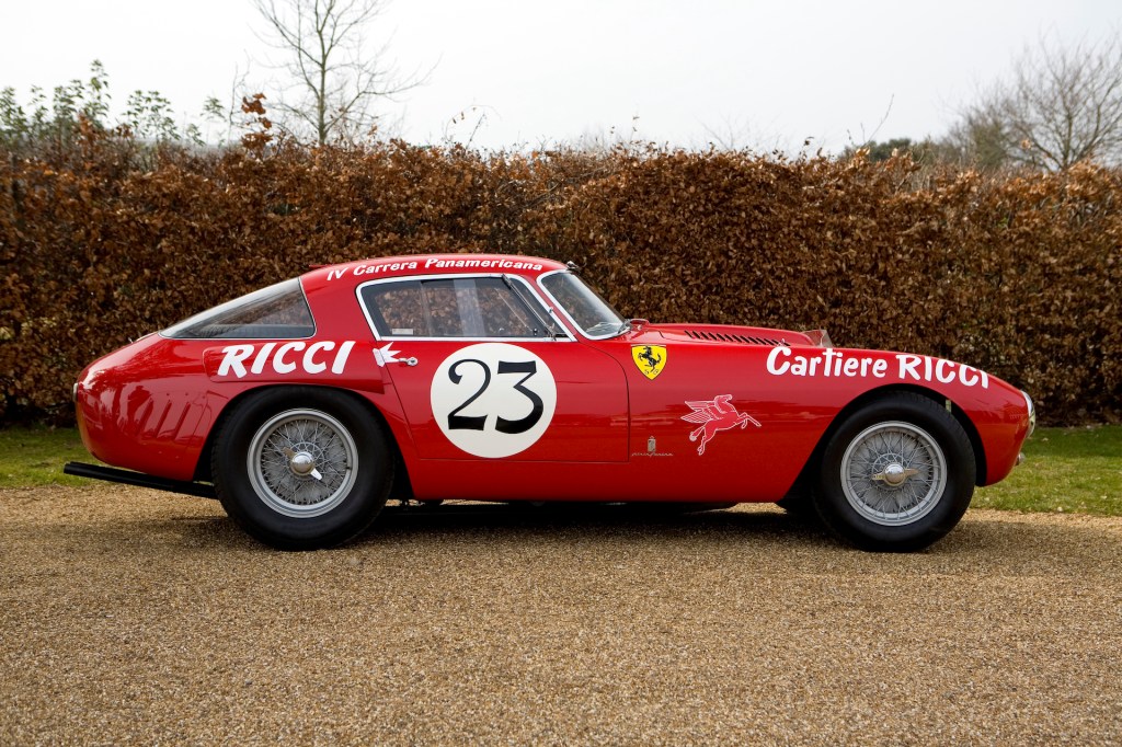 An image of a red Ferrari 375 MM parked outdoors.